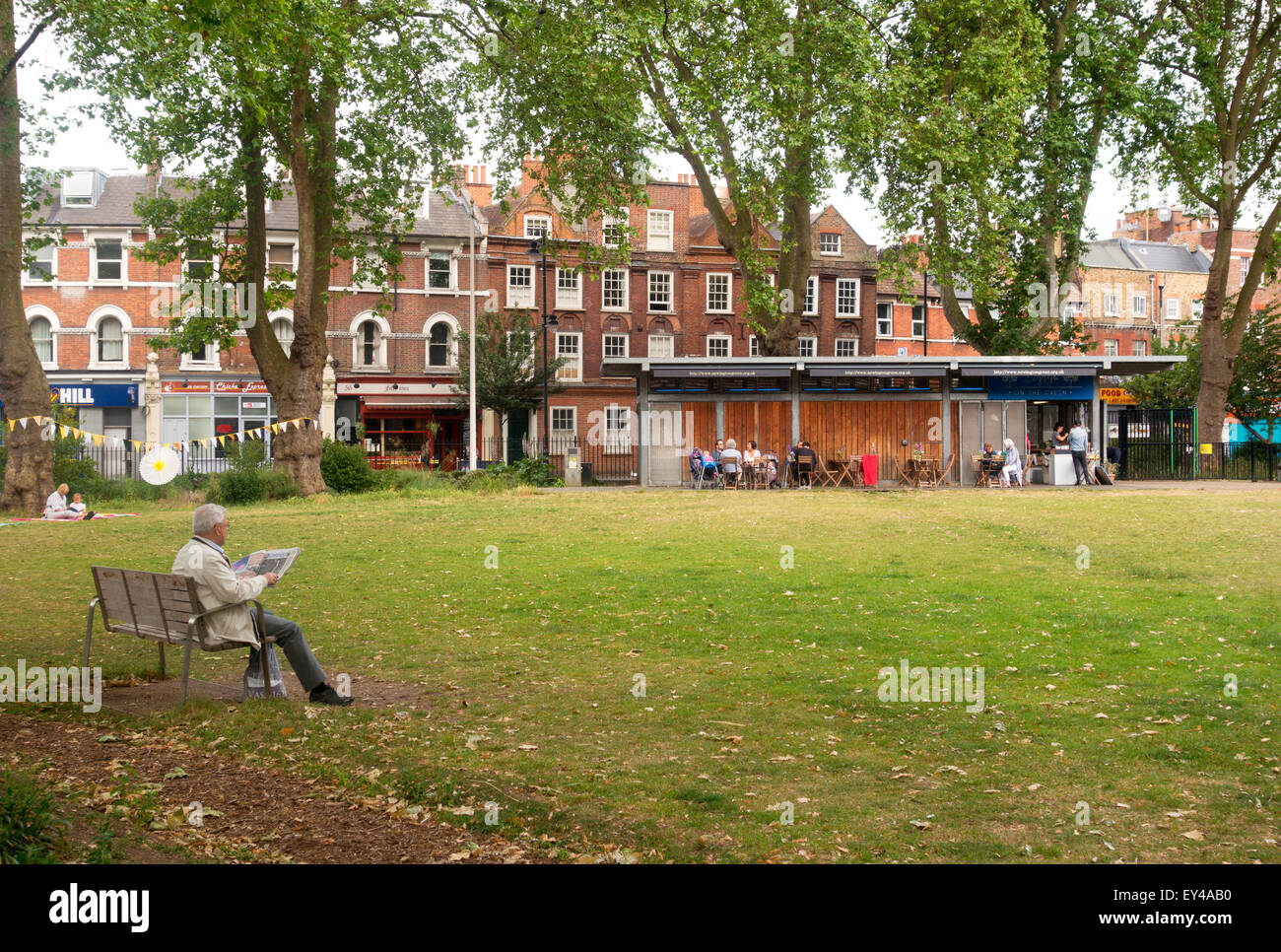 A man reading his newspaper, Newington Green, London borough of Islington, London England UK Stock Photo