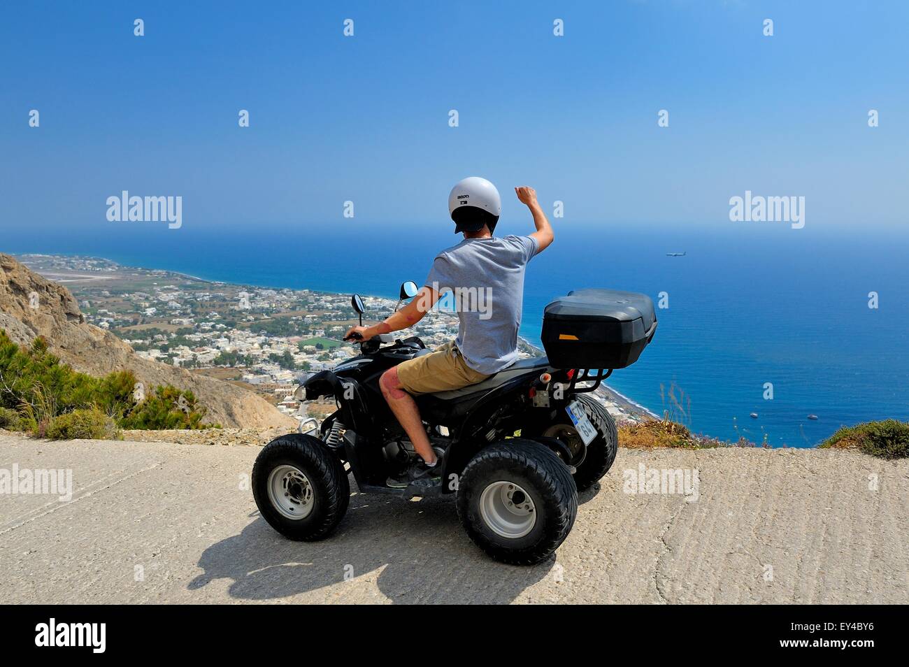 People riding an ATV quad rental bike in Kamari,Santorini Greece Stock