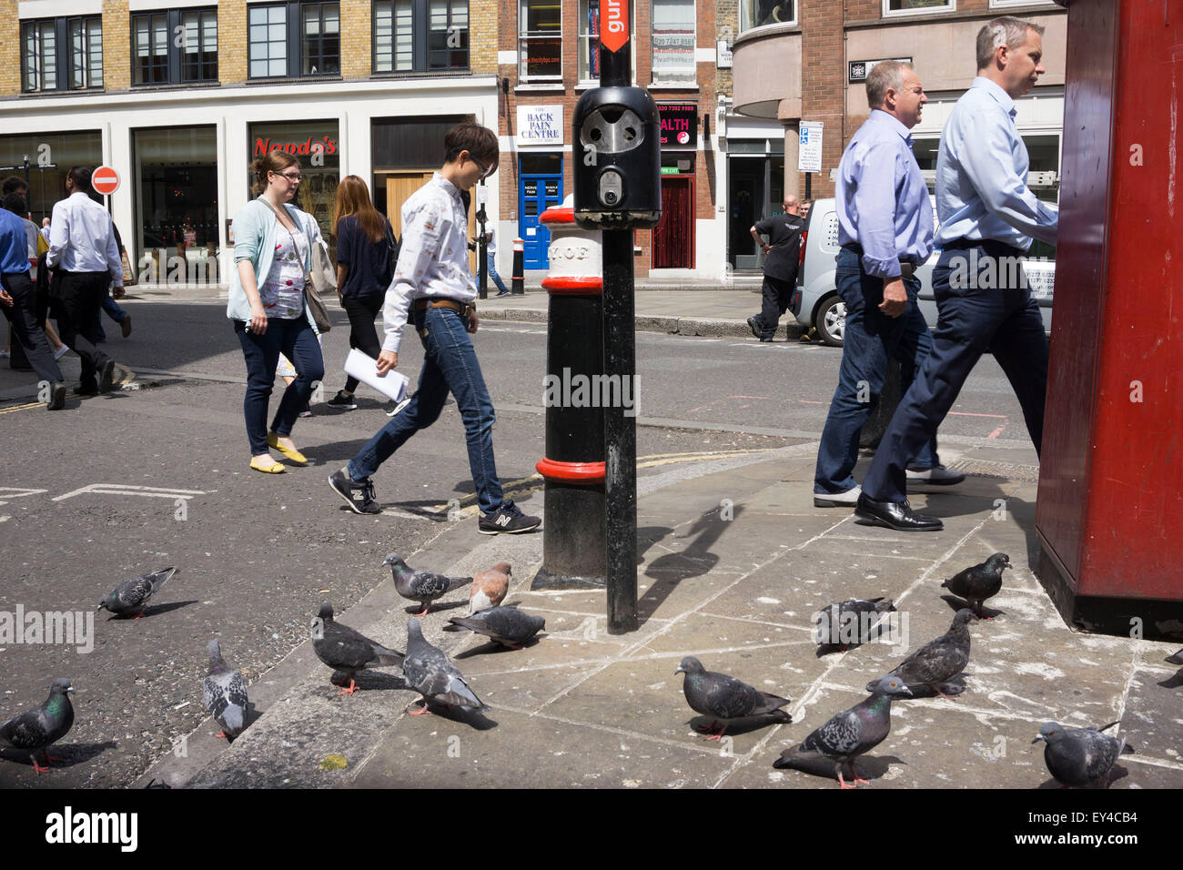 People Versus Pigeons In The City Of London UK On This Street Corner