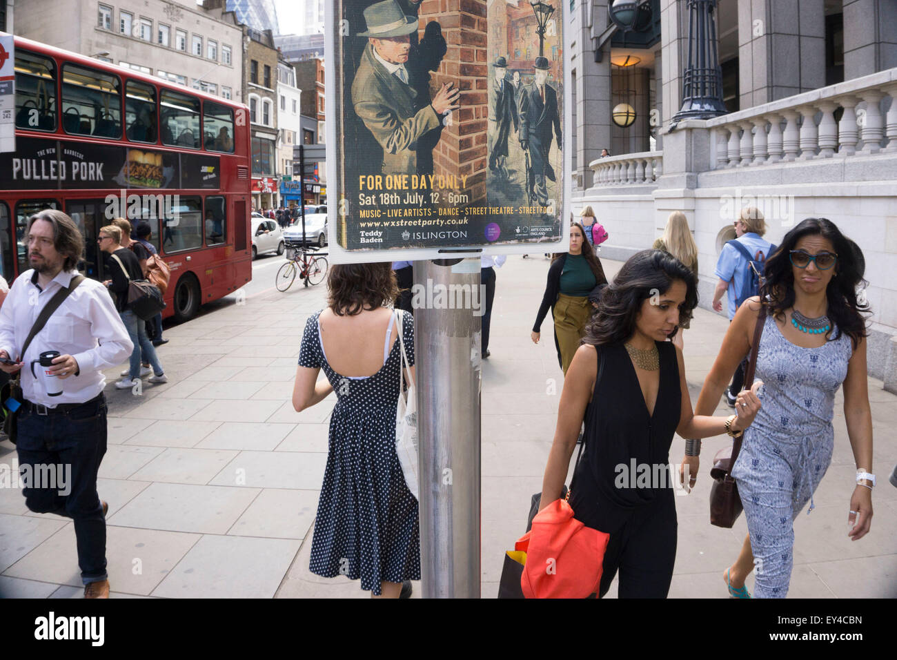 Sinister poster advertising for a club night, looks over the shoulders of passing people near to Liverpool Street station on Bishopsgate. London, UK. The character on the poster is that of a 1940s secret agent, private investigator or spy looking at his target. Stock Photo