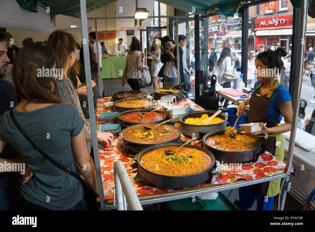 Food stalls inside at Brick Lane Market, London, UK. Foods from all ...