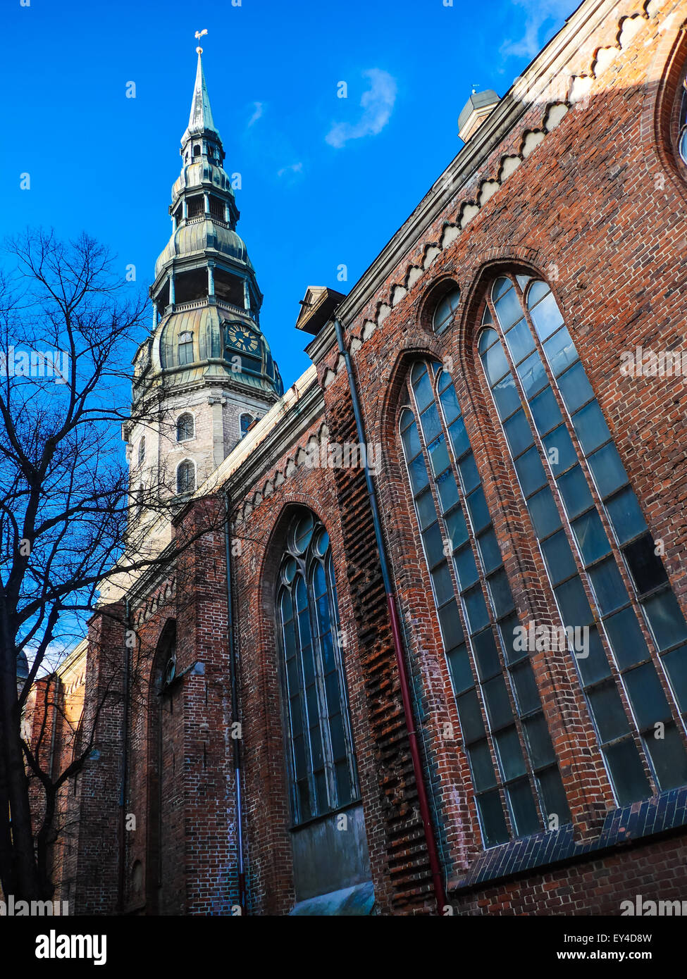 Latvia Riga City's historical center - Unesco world heritage site Saint Peter's Church and Hanseatic style building Stock Photo