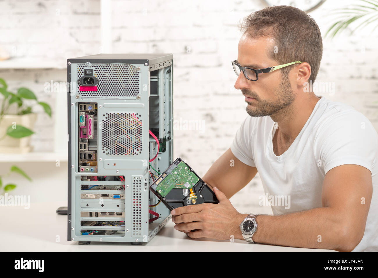 young engineer repaired a computer with a new hard disk Stock Photo - Alamy