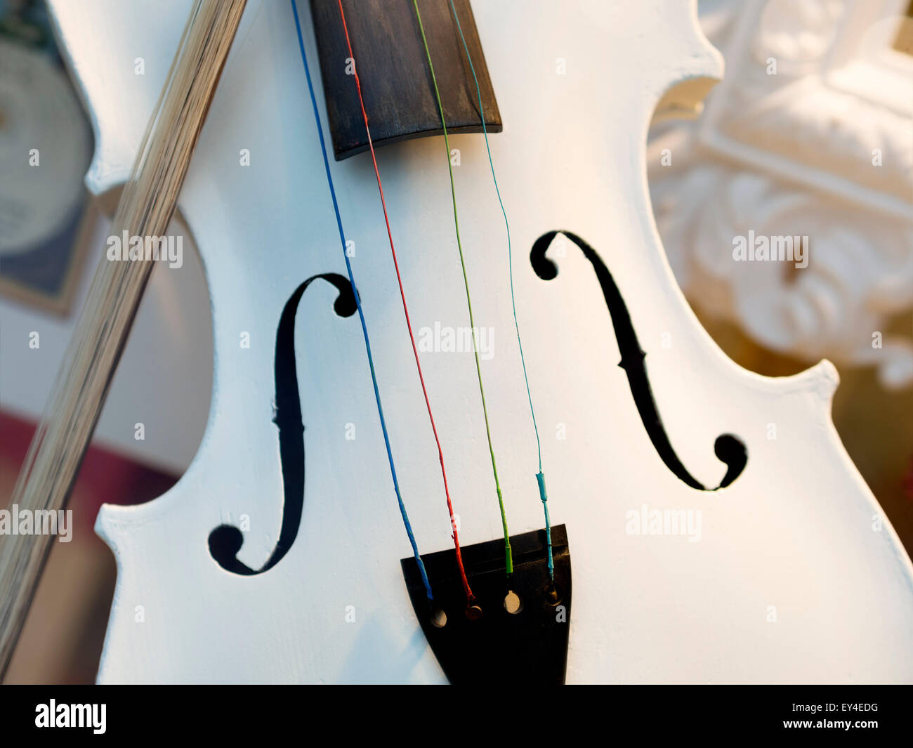 Image of a white violin with fiddlestick Stock Photo