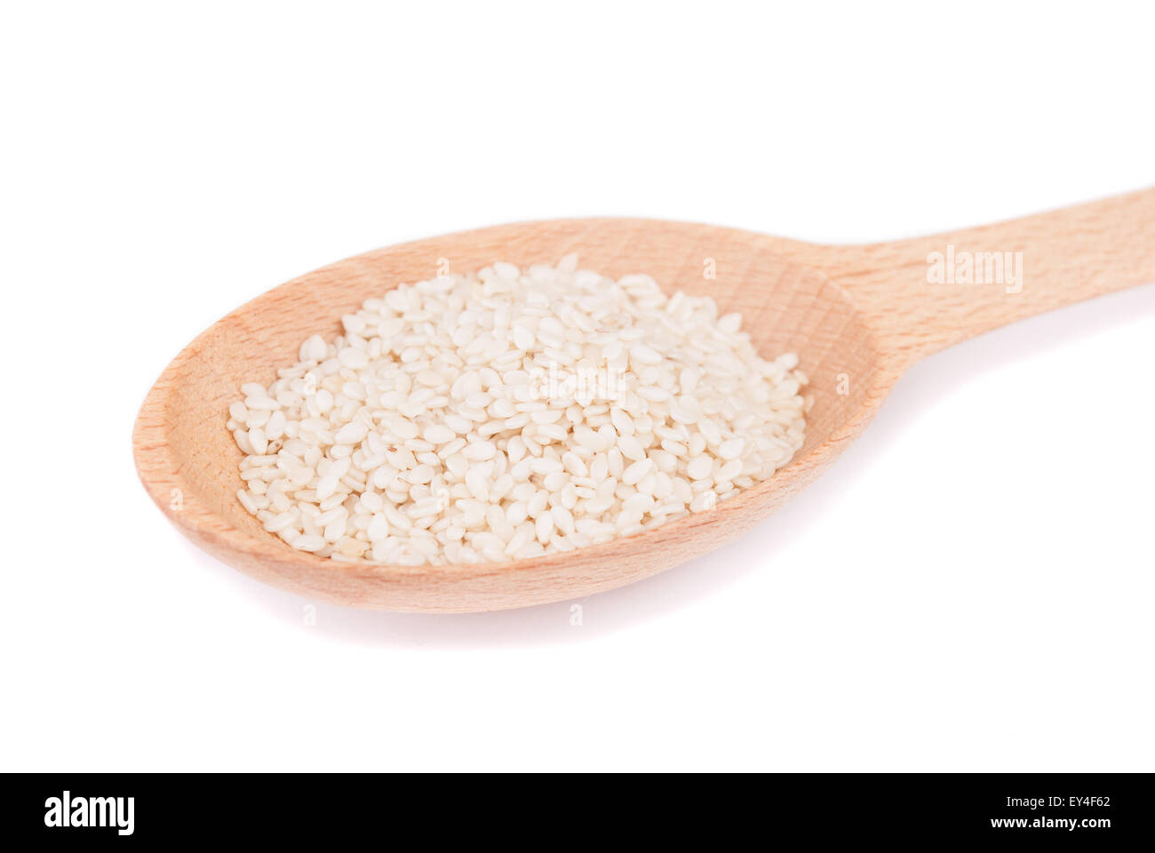 Sesame seeds in a spoon isolated on white background. Stock Photo