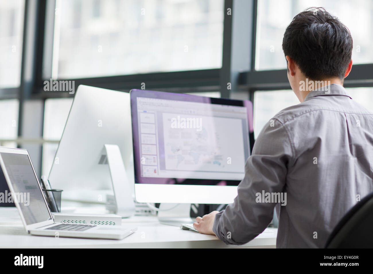 Young businessman using computer in office Stock Photo - Alamy