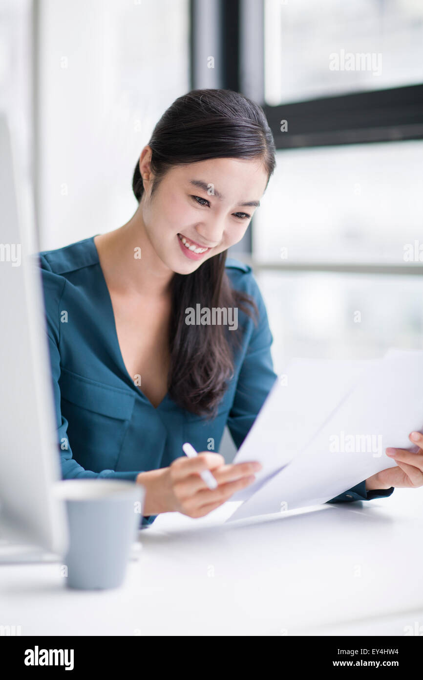 Young businesswoman working in office Stock Photo - Alamy
