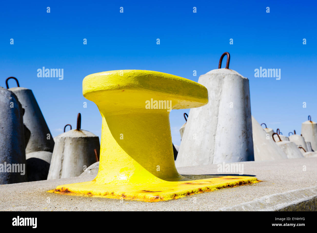 Mooring bollard painted in yellow Stock Photo
