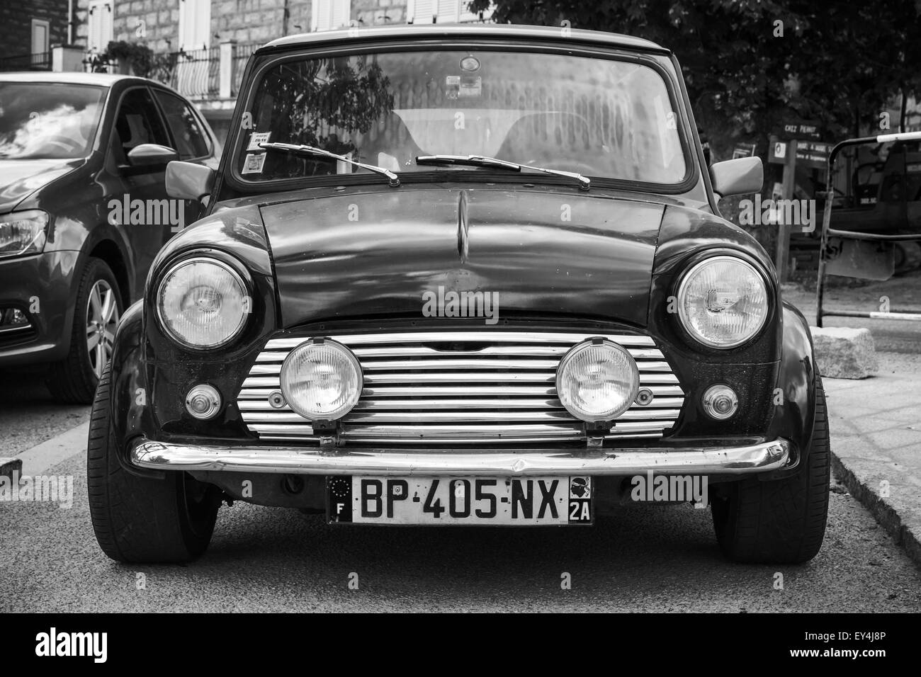 Quenza, France - July 1, 2015: Black Mini cooper car stands parked, closeup photo, front view Stock Photo