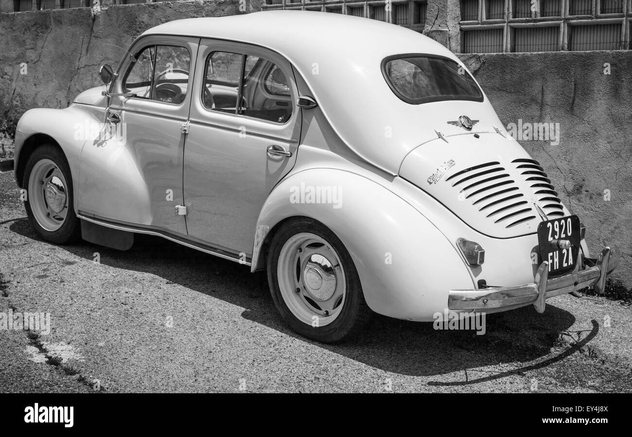 Ajaccio, France - July 6, 2015: White Renault 4CV old-timer economy car stands parked on a roadside in French town, rear view Stock Photo