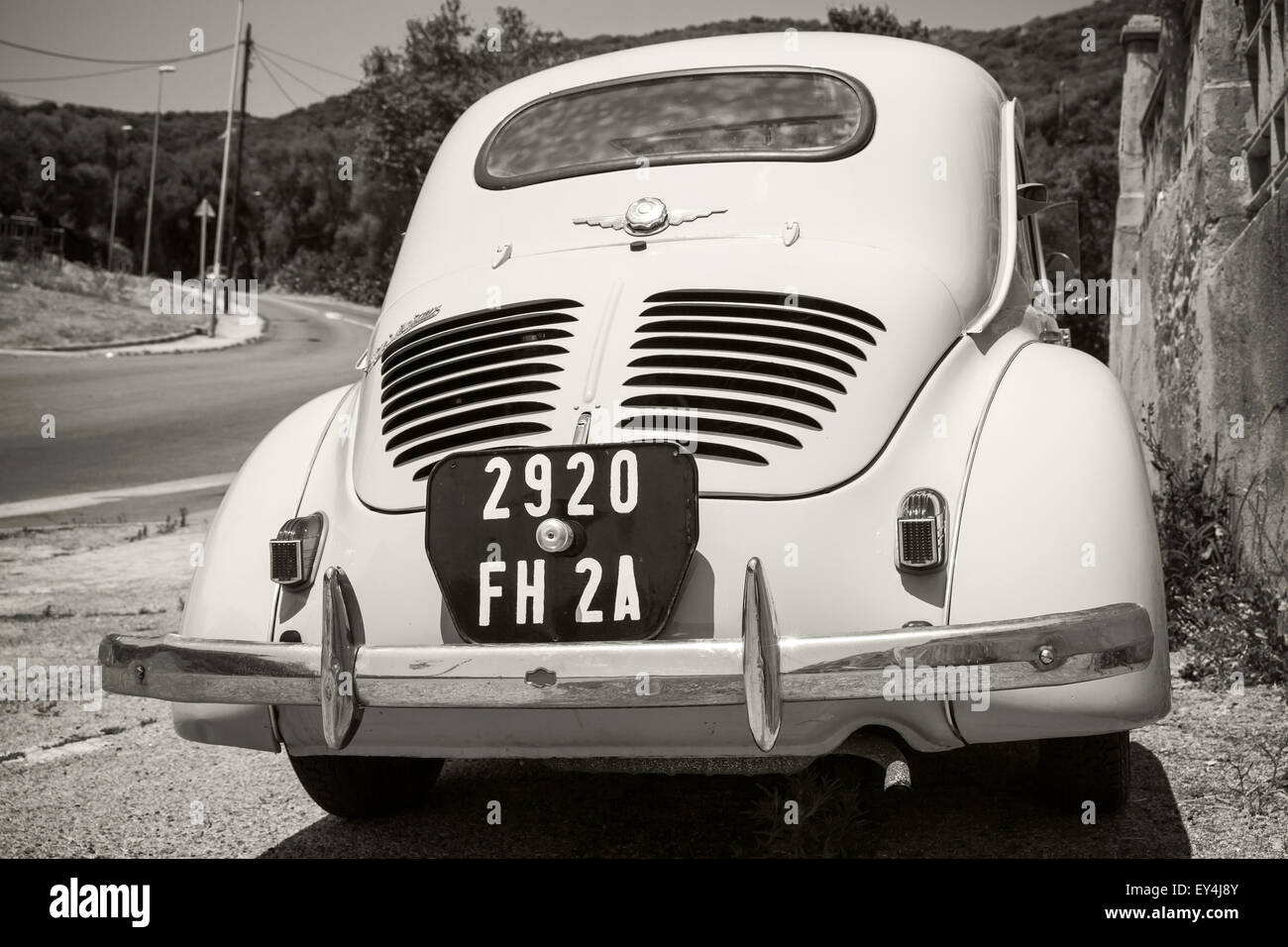 Ajaccio, France - July 6, 2015: White Renault 4CV old-timer economy car stands parked on a roadside in French town, close-up rea Stock Photo