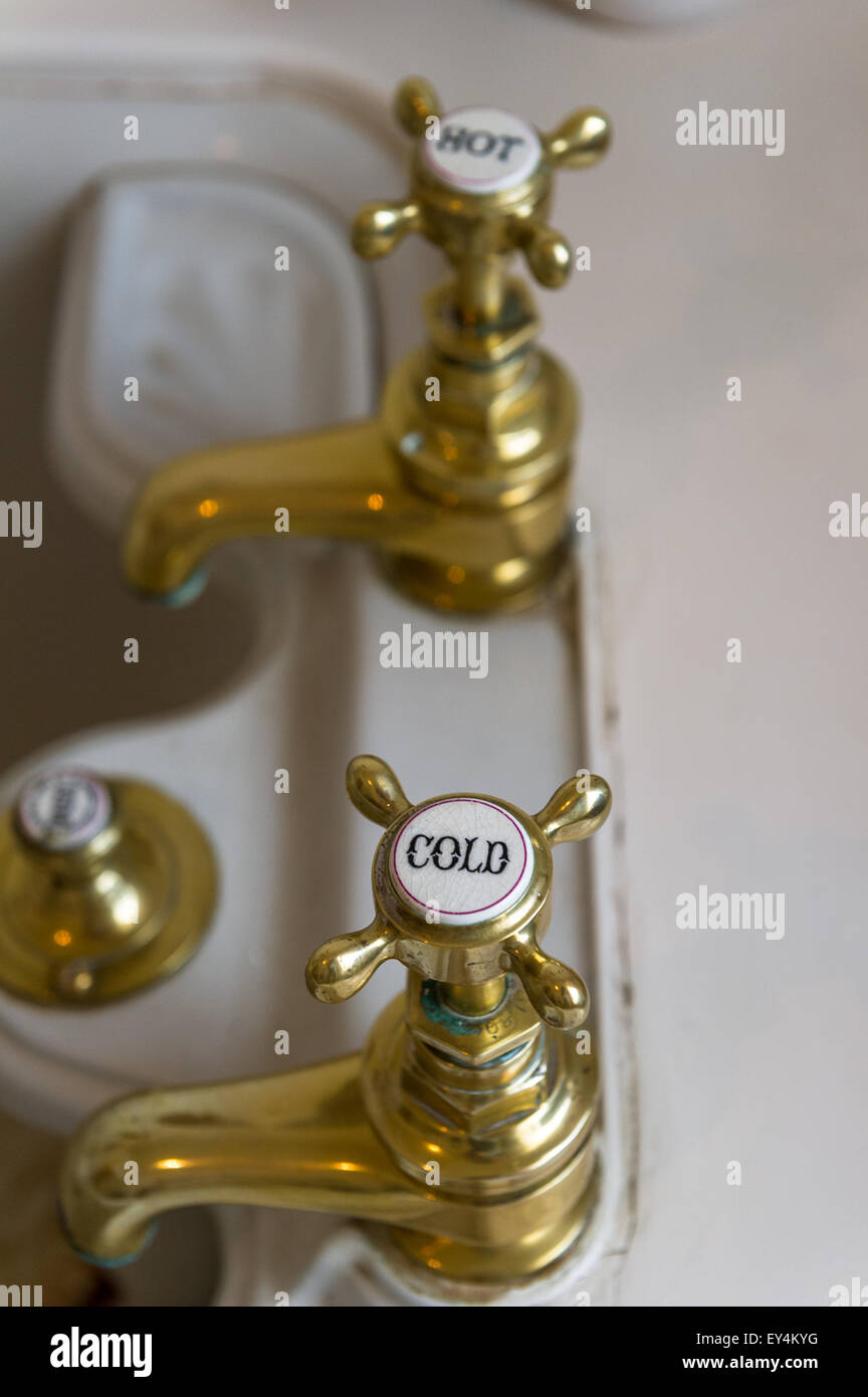 Victorian brass hot and cold water taps. Stock Photo