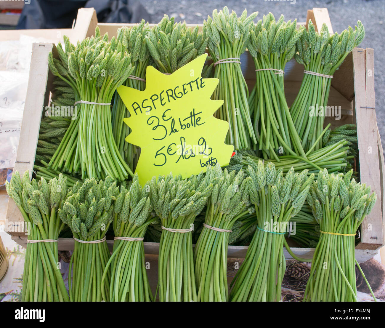 Bundles of asparagus tips for sale within the street market  in Millau, Averyon,  Midi-Pyrenees, France, Europe Stock Photo