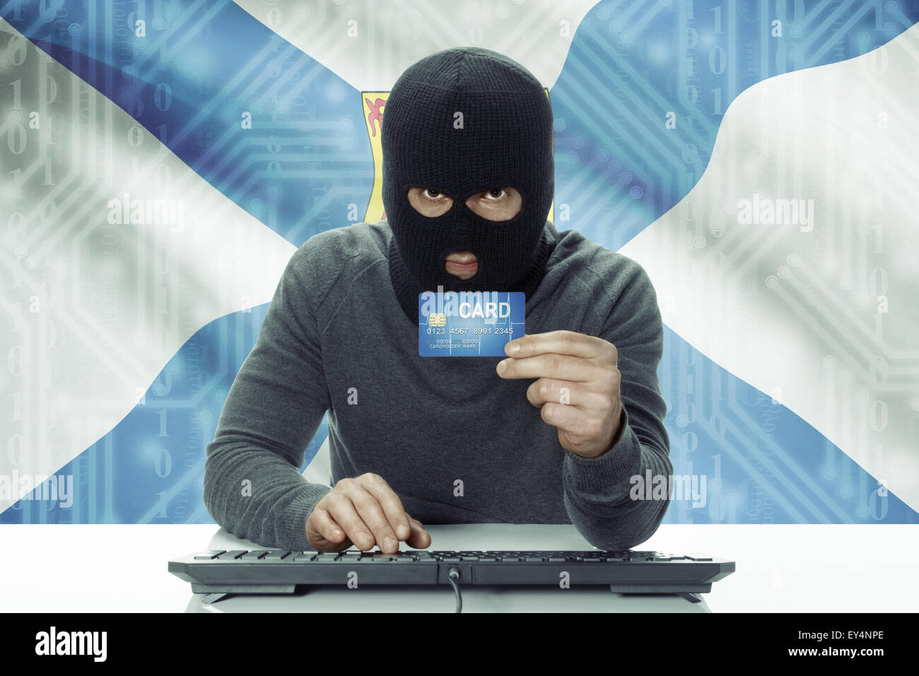 Dark-skinned hacker with credit card and Canadian province flag on ...