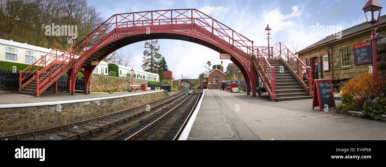Red painted bridge over the railway lines at Goathland railway station, in North Yorkshire Stock Photo