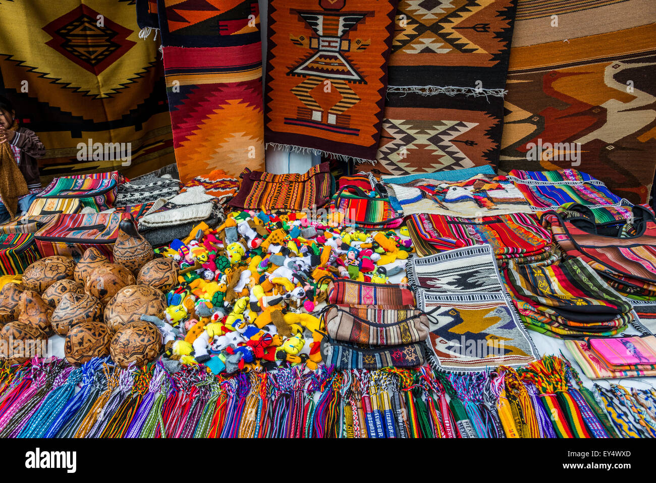 Hand-crafted local souvenirs for sale on a stand at weekend market. Otavalo, Ecuador. Stock Photo