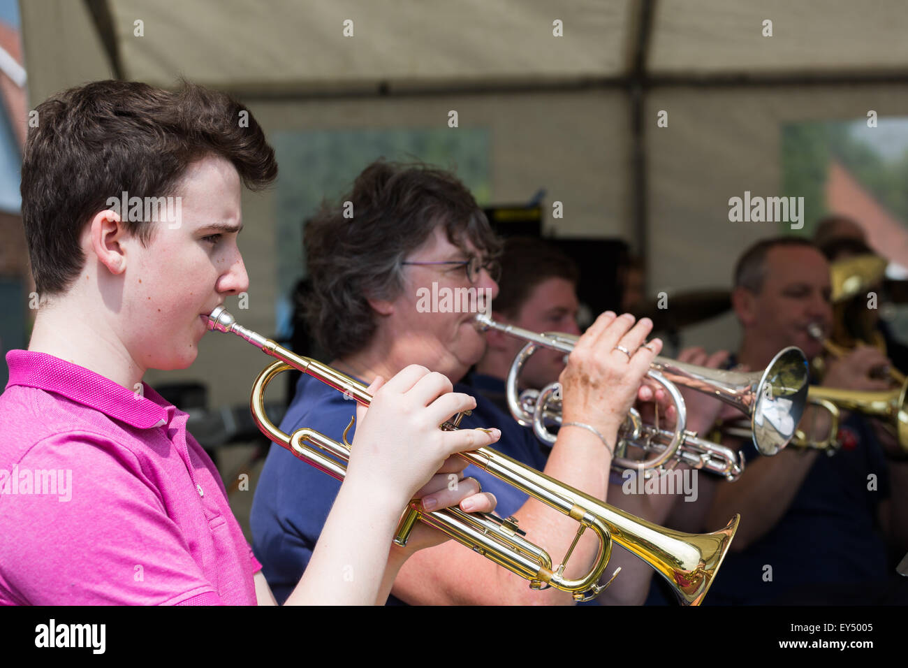Trumpeters playing their instruments in a brass music group / orchestra / band Stock Photo