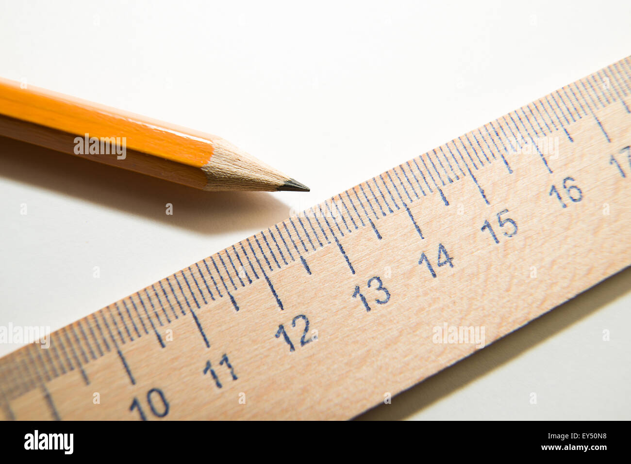 Notepad with a recording sheet, pencil and wooden ruler on a white ...