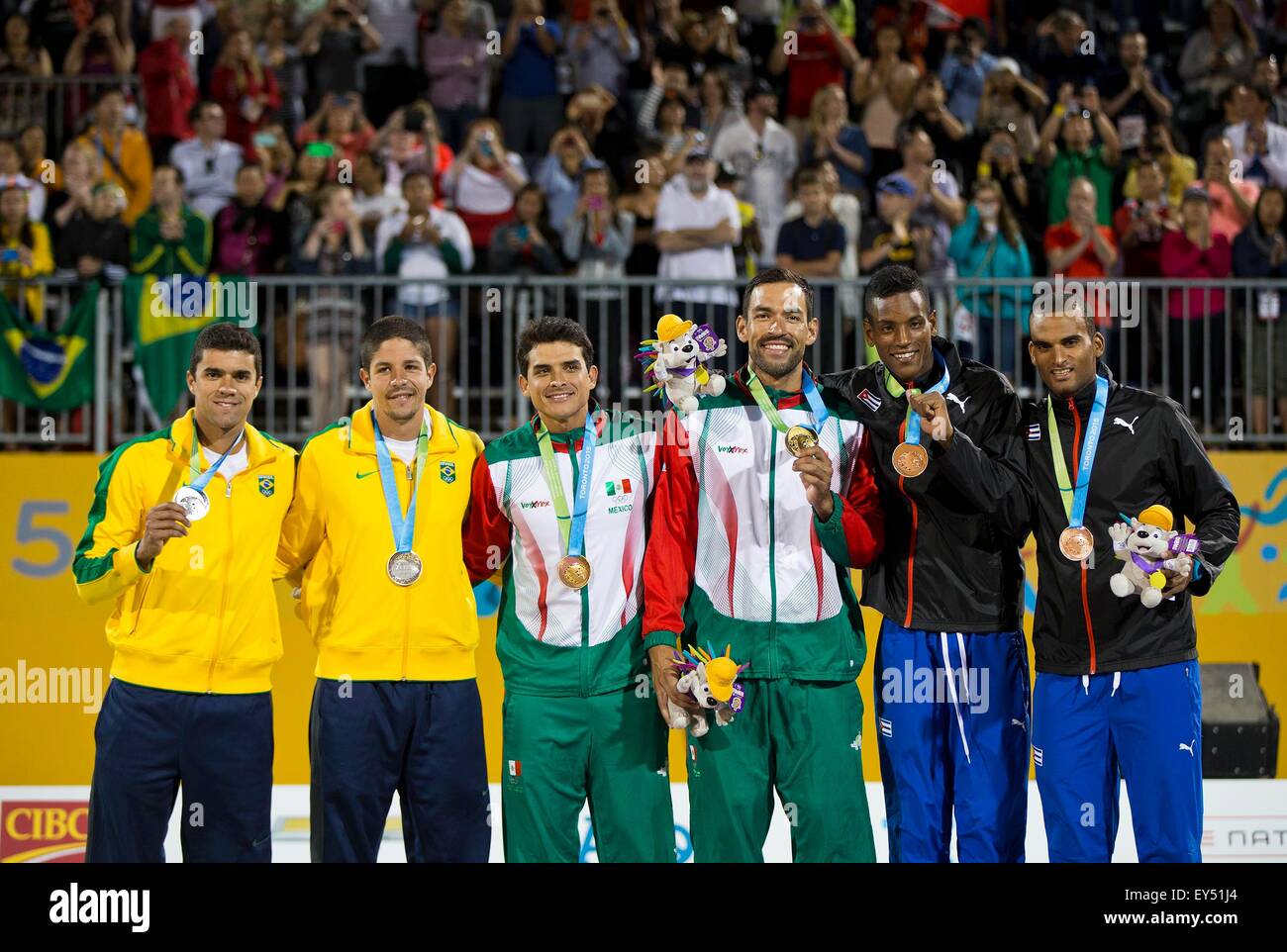 (150722) -- TORONTO, July 22, 2015 (Xinhua) -- Gold medalists Juan Virgen (3rd, R) and Rodolfo Ontiveros(3rd, L) of Mexico pose with silver medalists Vitor Araujo (1st, L) and Alvaro Magliano (2nd, L) of Brazil, and bronze medalists Nivaldo Diaz (2nd, R) and Sergio Gonzalez (1st, R) of Cuba during the awarding ceremony for Men's Beach Volleyball at the 17th Pan American Games in Toronto, Canada on July 21, 2015. Juan Virgen and Rodolfo Ontiveros claimed the title after defeating Vitor Araujo and Alvaro Magliano of Brazil with 2-1 in the gold medal match. (Xinhua/Zou Zheng)(wll) Stock Photo