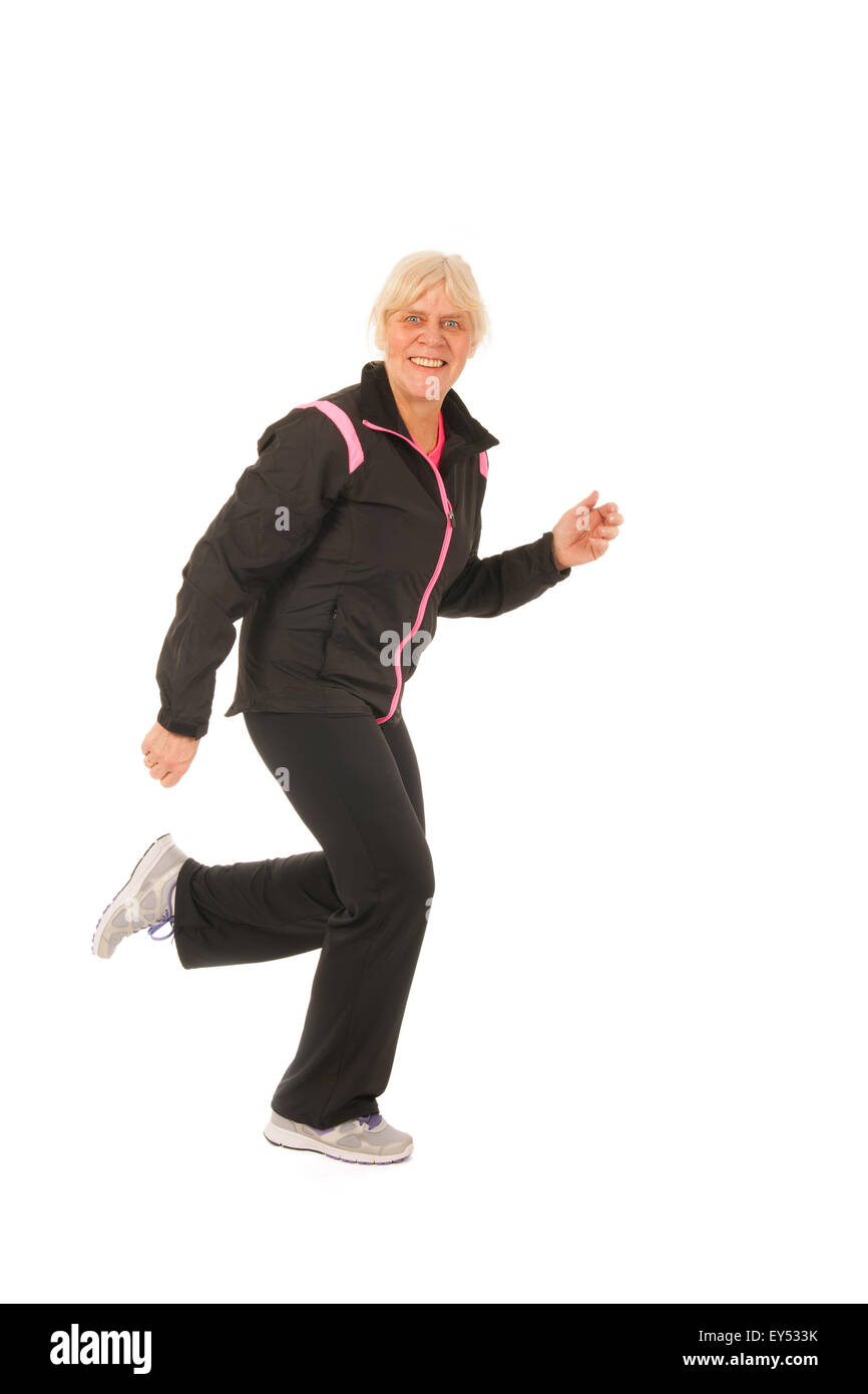 Woman of mature age is running in the studio Stock Photo