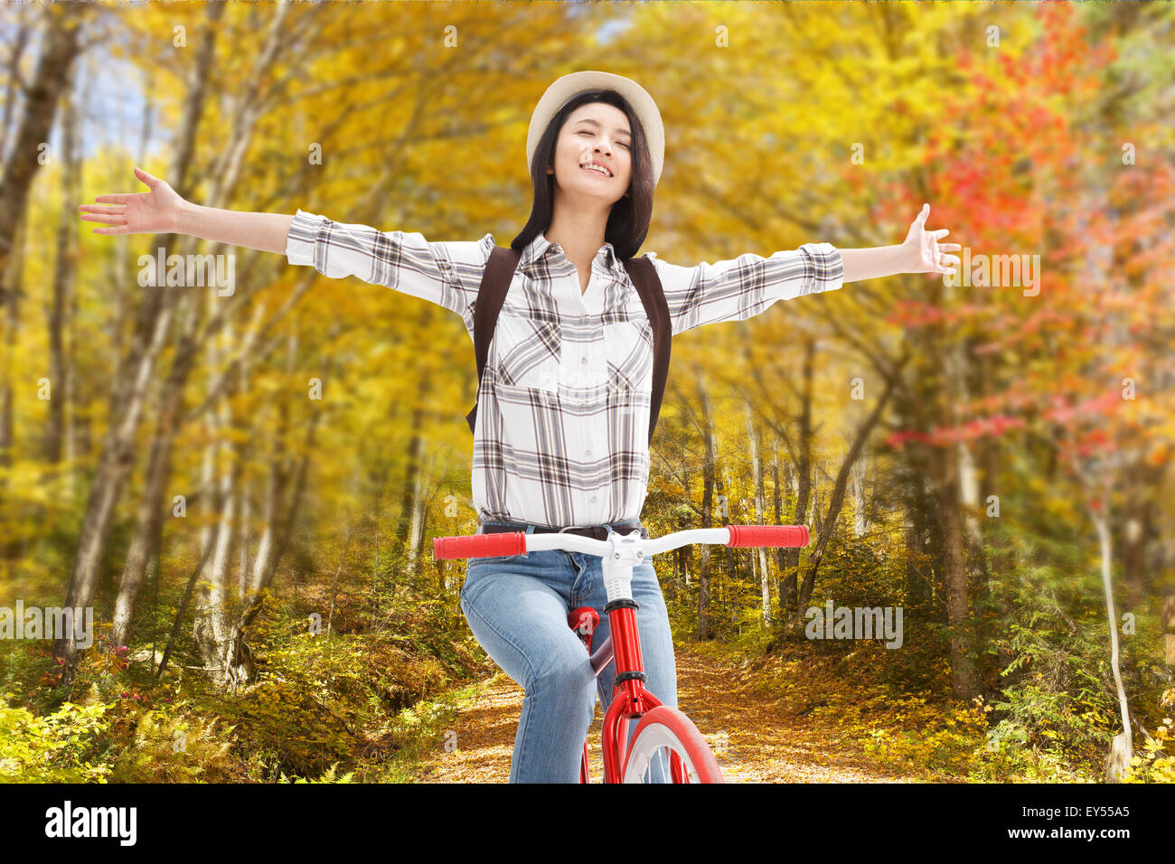 Young woman riding a bike trip Stock Photo Alamy