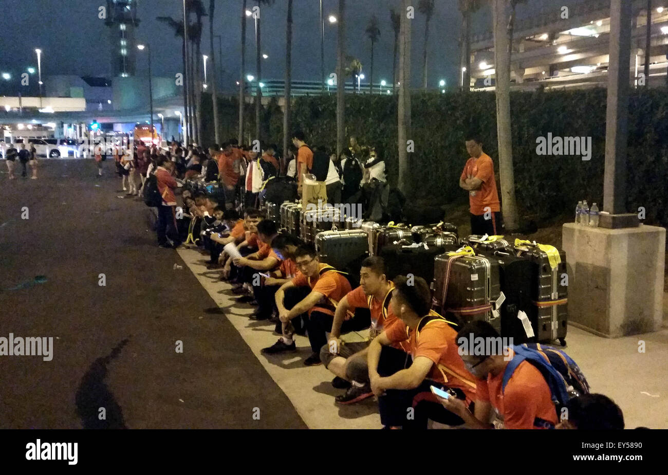 Los Angeles, USA. 21st July, 2015. Chinese national team for 2015 Special Olympics World Summer Games wait for the shuttle bus at the Los Angeles International Airport in California, the United States, July 21, 2015. Due to the transportation failure of the Organizing Committee of 2015 Special Olympics World Summer Games, a lot of teams arriving at the airport stranded for a long time. Chinese national team got to leave the airport at 23:55 after nealy 4 hours waiting. © Zhao Qian/Xinhua/Alamy Live News Stock Photo
