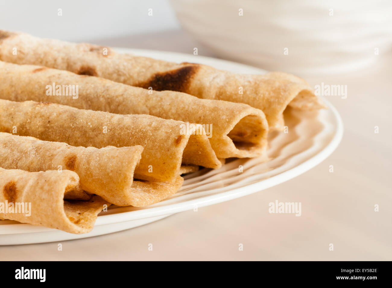 Closeup of folded homemade wheat chapati (indian bread) arranged on a plate. Shallow Depth of field. Stock Photo