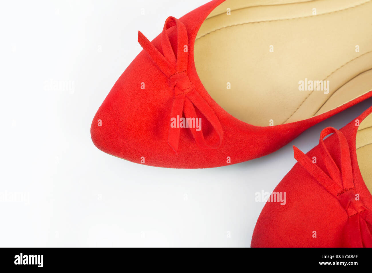 Pair of red female shoes over white background Stock Photo - Alamy