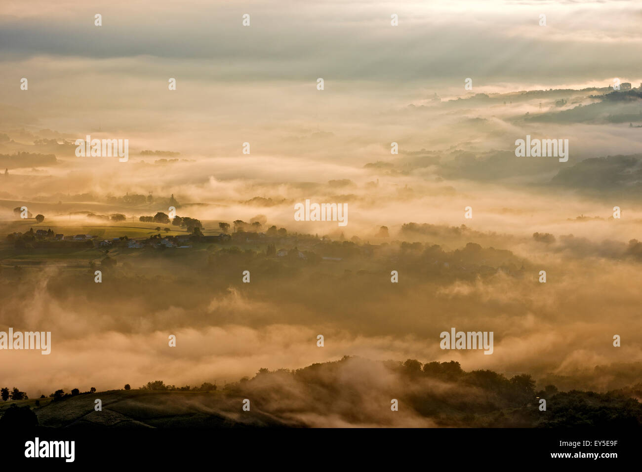 Mists of Savoyard countryside at dawn - France after a stormy night Stock Photo