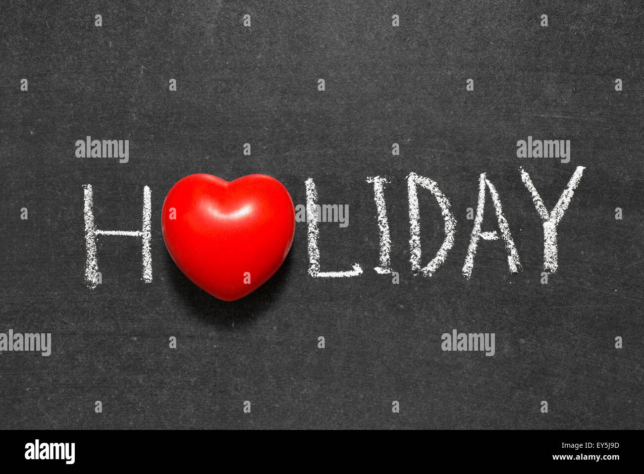 holiday word handwritten on chalkboard with heart symbol instead of O Stock Photo