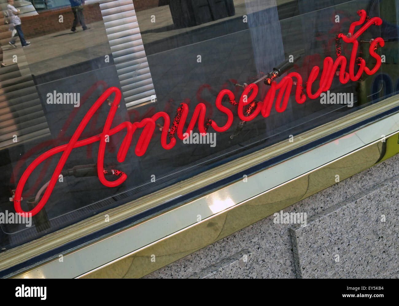 Red Neon Amusements sign in a window Stock Photo