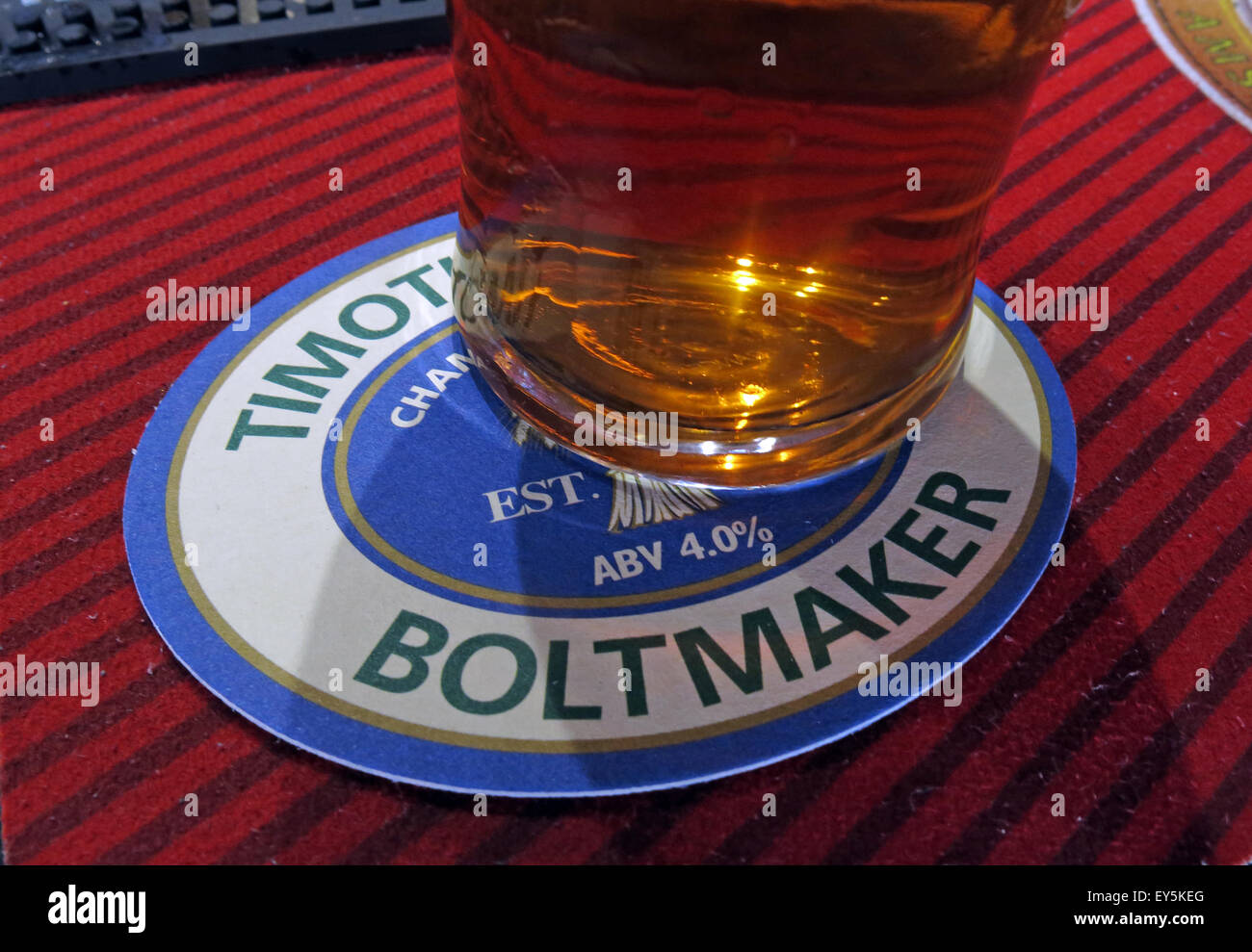 A pint of Timothy Taylor Boltmaker Bitter, in a bar, Yorkshire, England, UK on a beermat Stock Photo