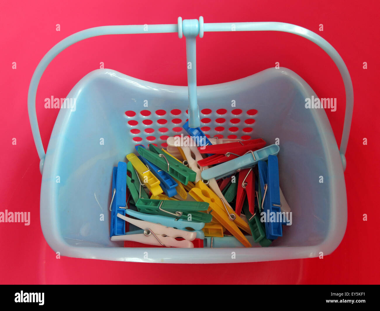 Bright Washday clothes pegs for washing line, in red,blue, yellow,green basket Stock Photo