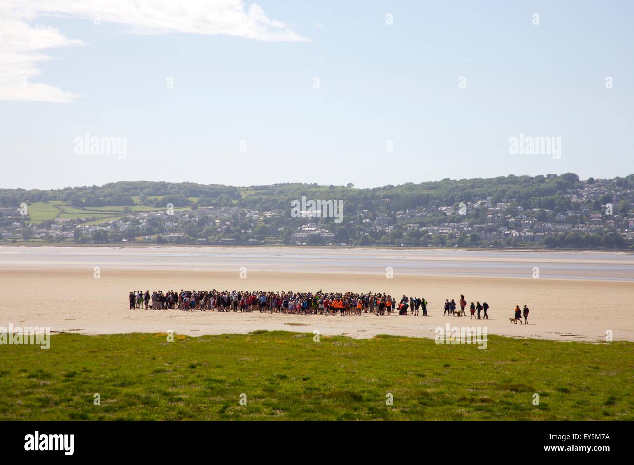 Walkers setting off with the Queen's Guide to cross Morecambe Bay from Arnside to Kents Bank, Cumbria Stock Photo