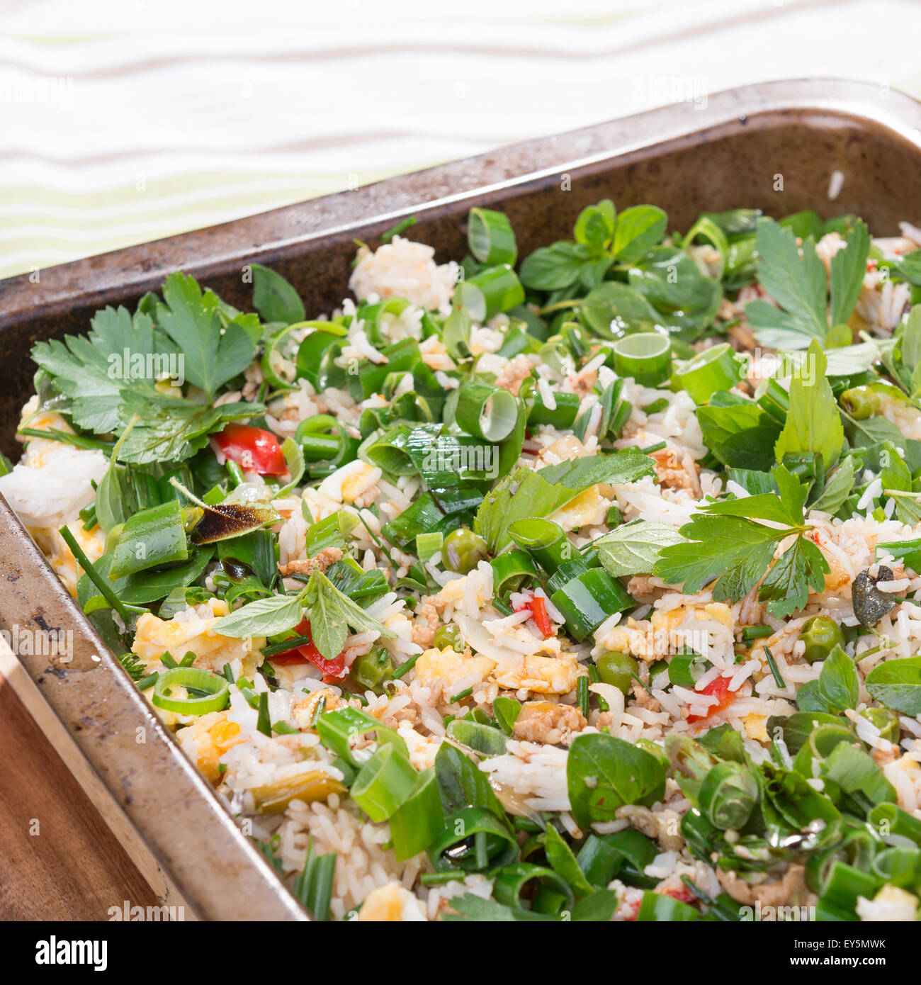 Fresh summer style fried rice with spring onions, egg, chicken and garden herbs Stock Photo