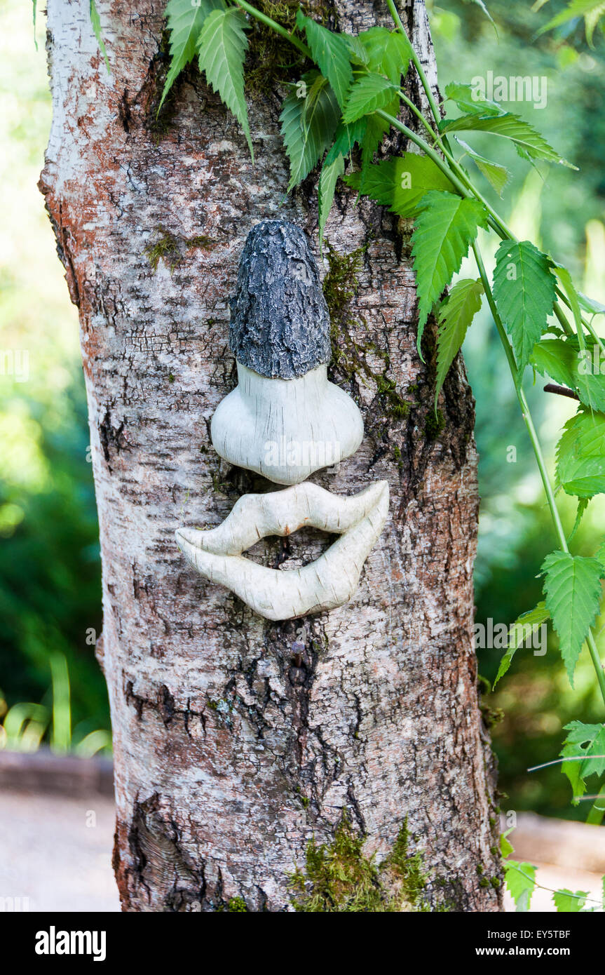 Garden sculpture on a Japanese rose trunk Stock Photo Alamy