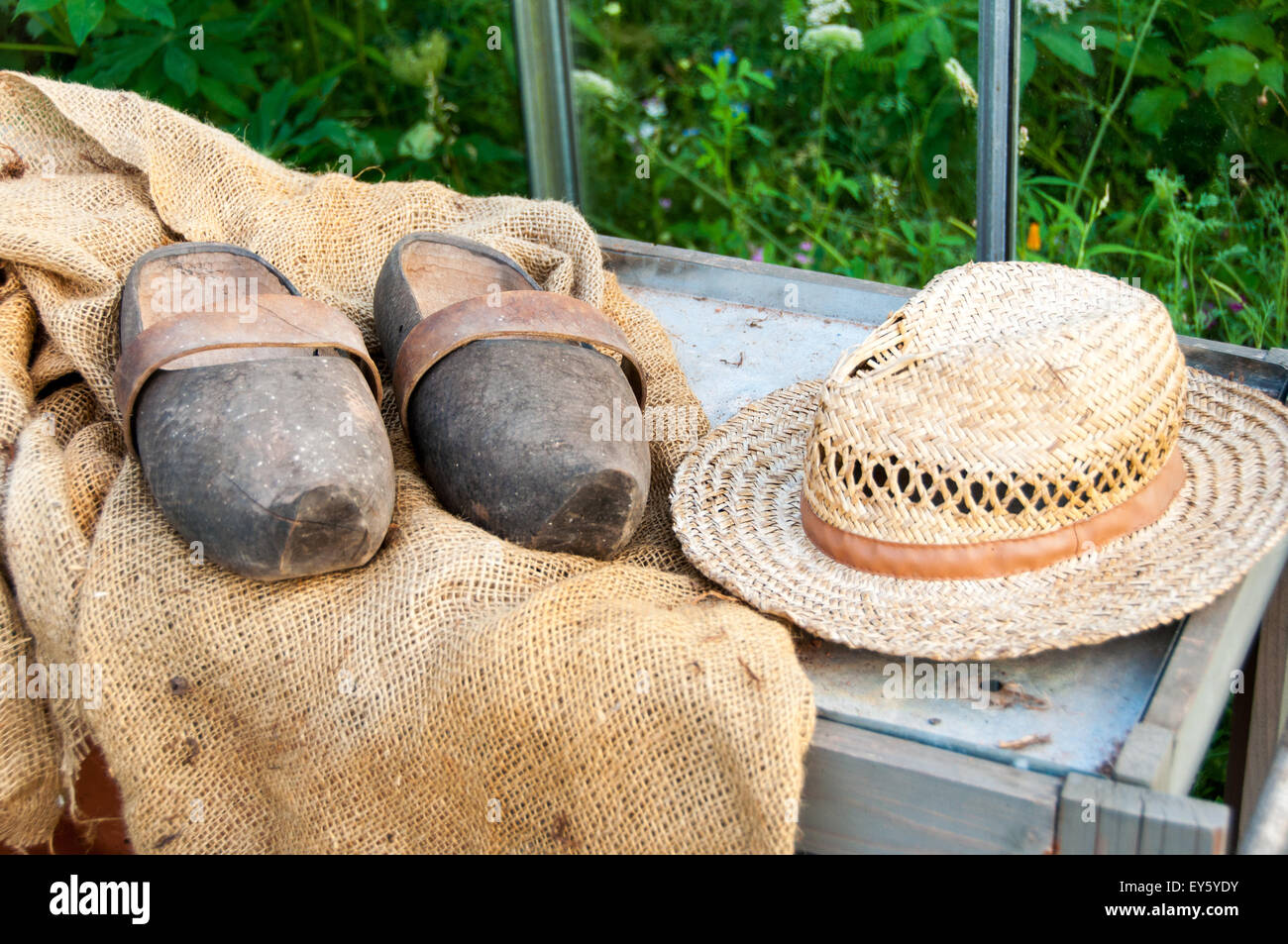 Hat and garden clogs on hessian Stock Photo Alamy