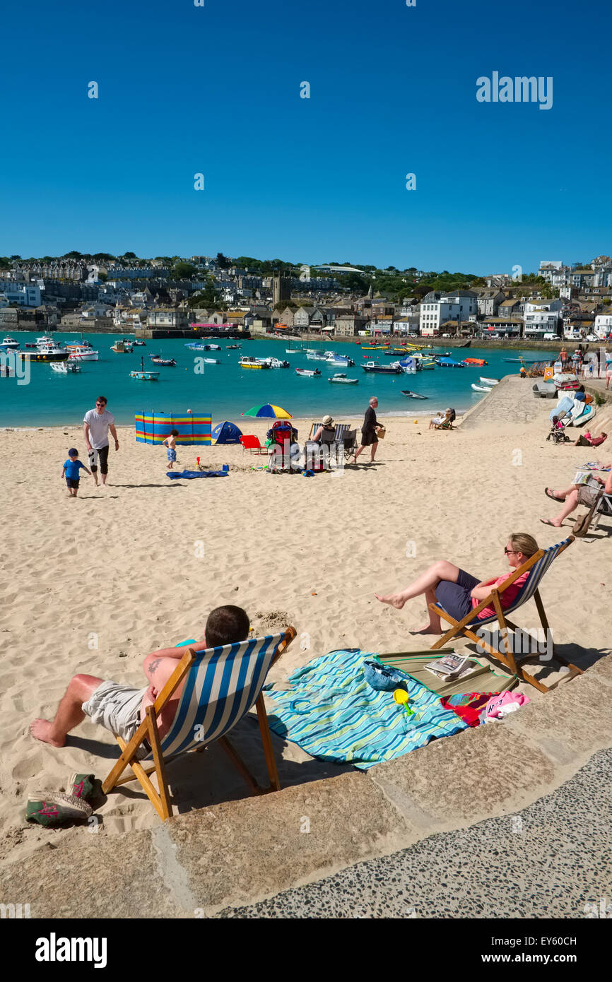 People sunbathing on the beach at St. Ives, Cornwall, England, UK Stock Photo