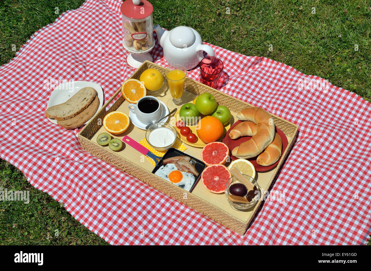 Colorful picnic breakfast or brunch with fresh coffee, ham and egg