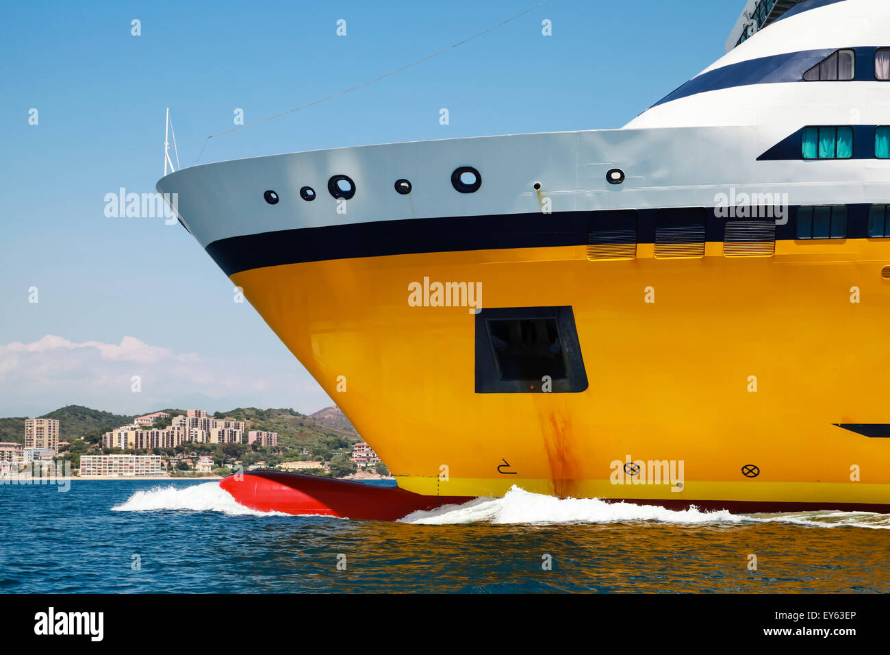 Big yellow passenger ferry ship goes on speed in the Mediterranean Sea. Bow fragment Stock Photo