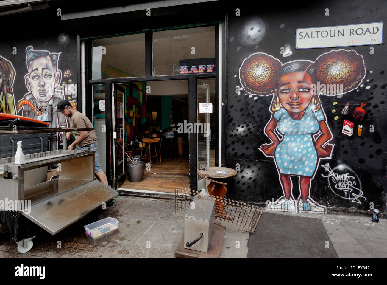 Brixton, London, UK. 22nd July, 2015. The popular Kaff Bar on Atlantic Road in Brixton has been forced to close due to the landlord tripling the rent.  Co-owner Stephen Ross starts the clear out which will include covering up the acclaimed street art. Credit:  Honey Salvadori/Alamy Live News Stock Photo