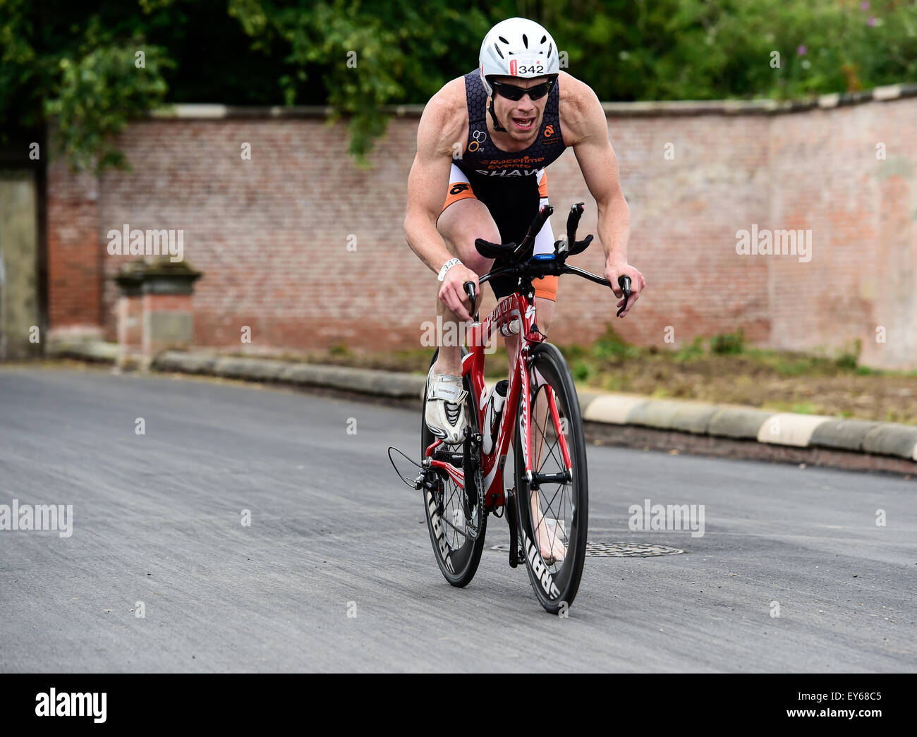 Triathlete Carl Shaw on the bike split during the 2015 Jenson Button Trust Triathlon in aid of Cancer Research Stock Photo