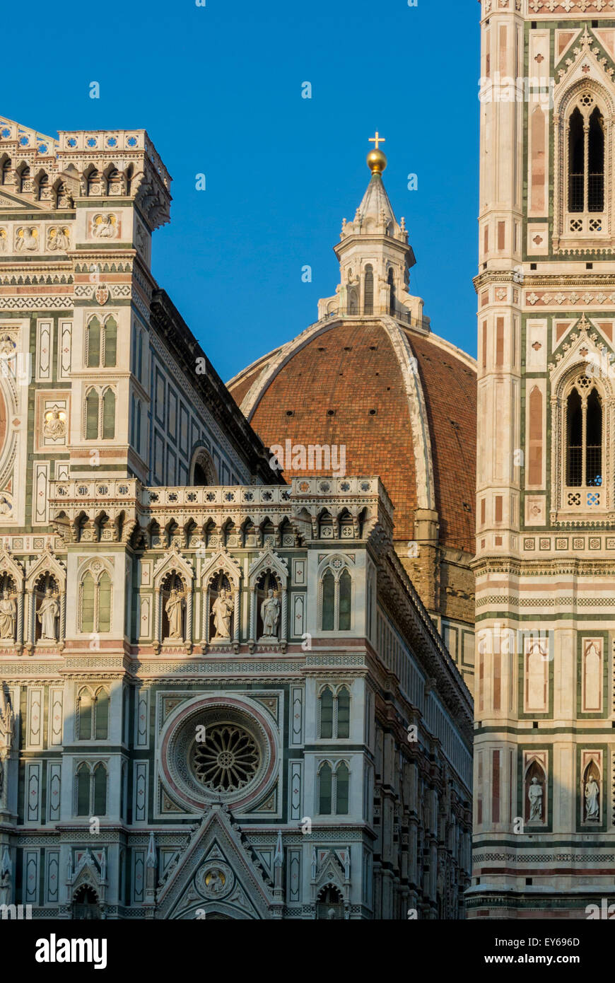 Florence Cathedral dome designed by Filippo Brunellesch, glimpsed between the west façade and the Giotto bell tower. Florence, Italy. Stock Photo