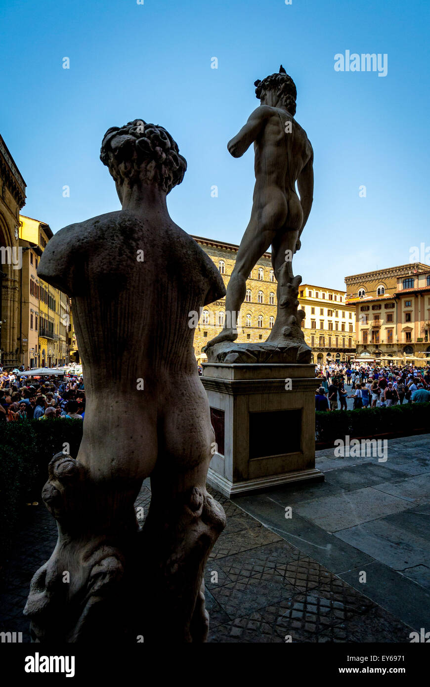 Rear view of statues, including Michelangelo's David seen from the entrance of the Palazzo Vecchio. Florence, Italy. Stock Photo