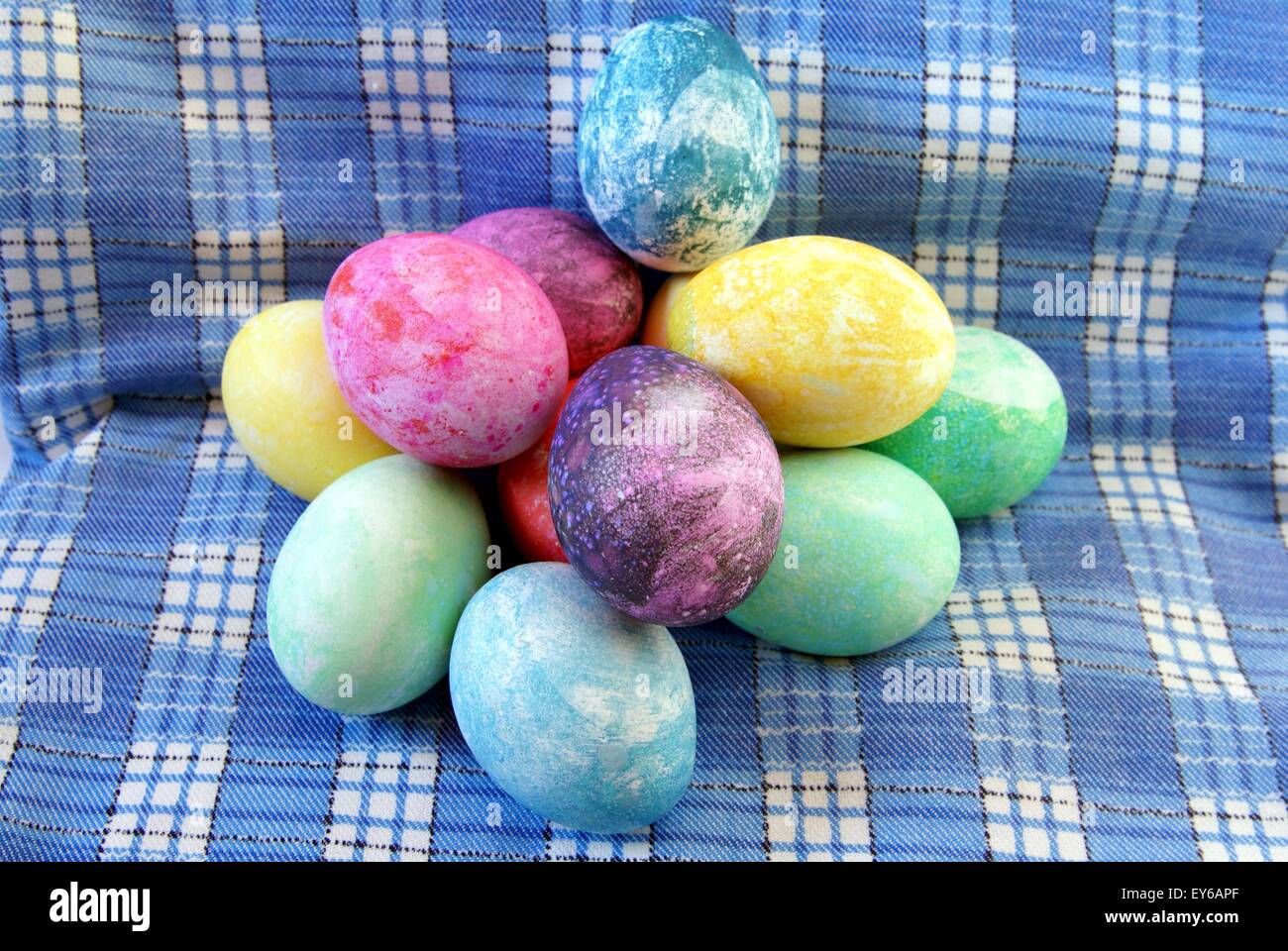 Colored easter eggs with decorative marble and tie die design piled