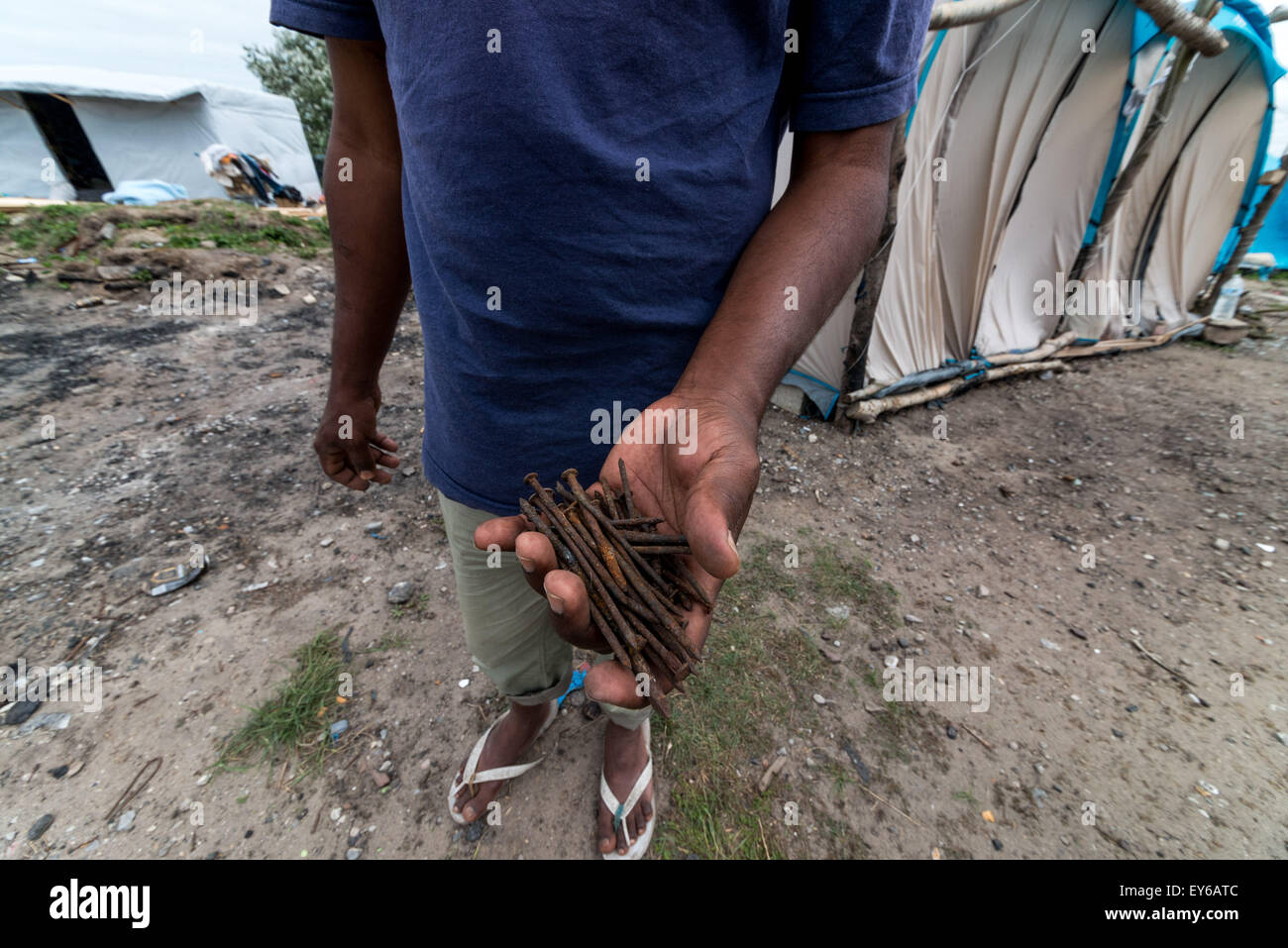 Calais, France. 22nd July, 2015. Refugees from Afghanistan, Syria, Sudan, and Eritrea steadily descend on a migrant camp in the French coastal town of Calais. They hope to gain entry to the UK, just 21 miles away across the English Channel. But in May, French police destroyed their camp and told the migrants to go elsewhere. And so they moved. across the street. (Credit Image: © Velar Grant via ZUMA Wire) Credit:  ZUMA Press, Inc./Alamy Live News Stock Photo