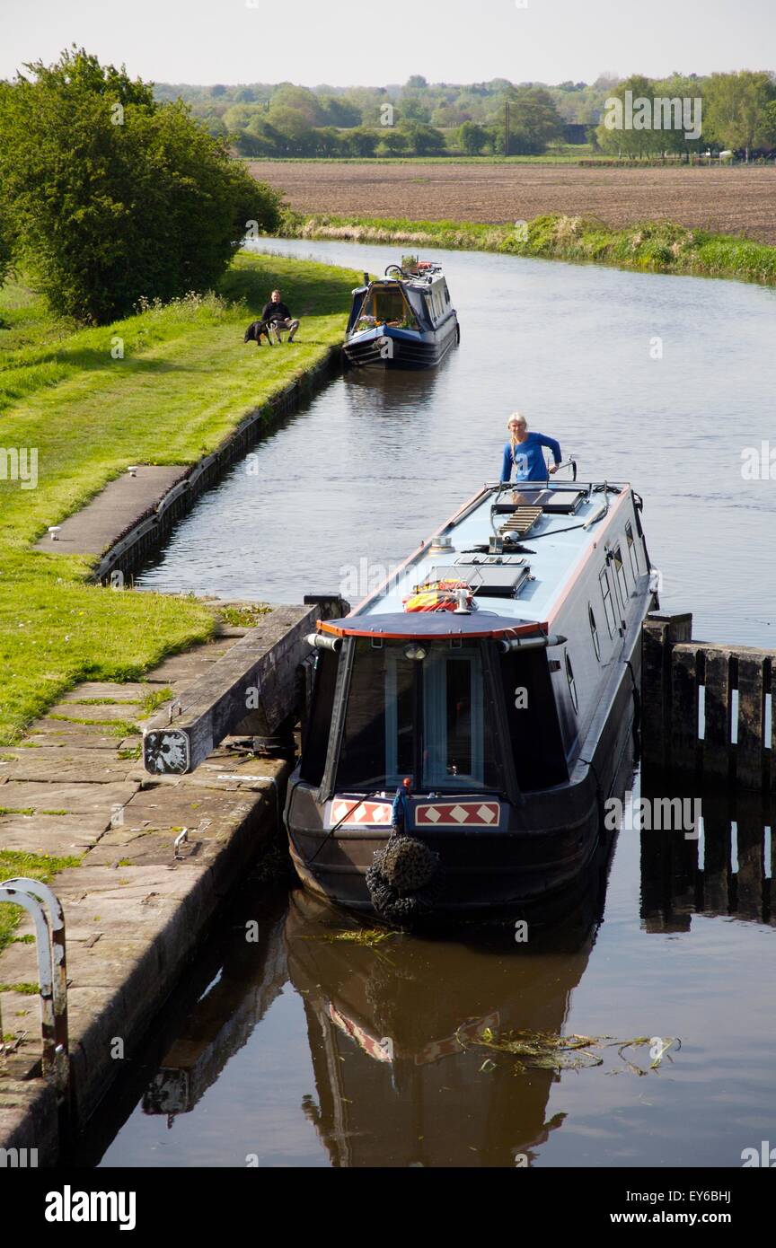 narrowboat entering a lock on Rufford Branch of Leeds & Liverpool canal near Burscough, Lancashire Stock Photo