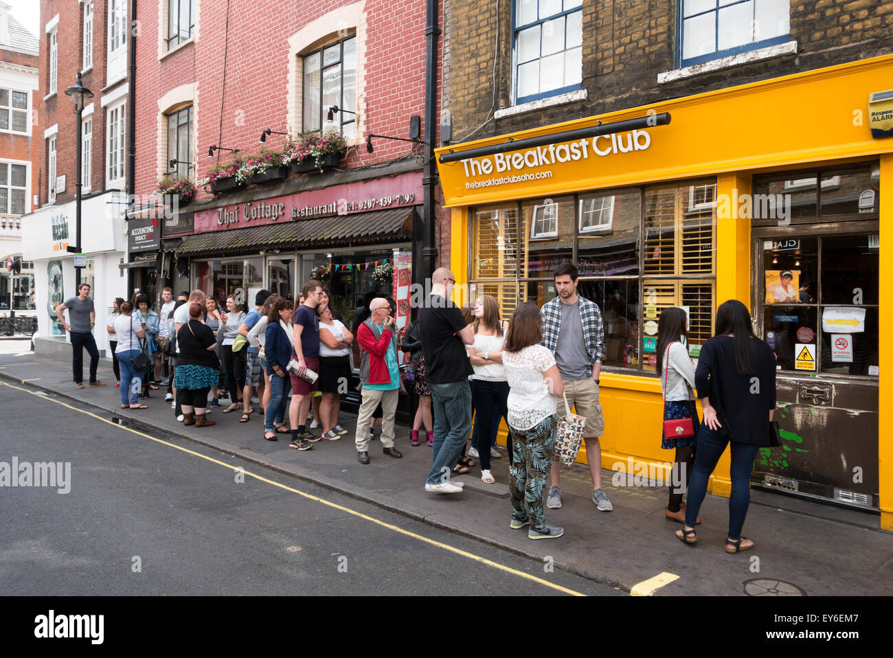 People queuing up outside the popular Breakfast Club cafe restaurant, D'arblay St, Soho, London UK Stock Photo