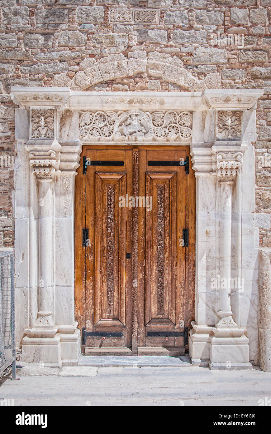 Wooden doors with an ornate marble doorway from the church of Saint