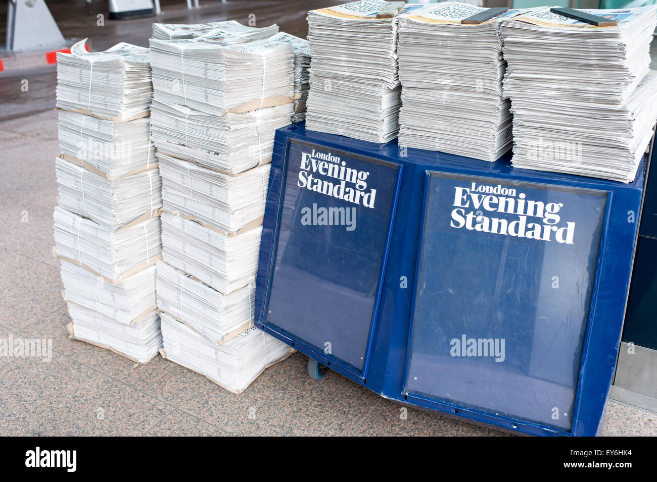 Newspapers stacked up next to a stall Stock Photo